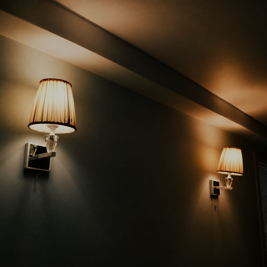 Pair of pleated wall sconces casting warm light across walls